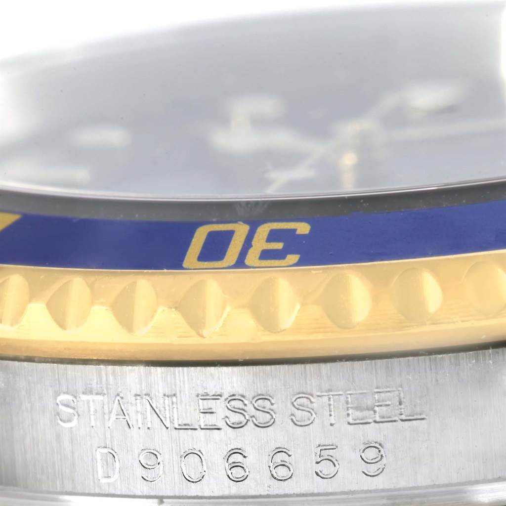 The image shows a close-up view of the bezel and serial number engraving on a Rolex Submariner 16613 Men's Steel and Gold (two tone) Blue Dial 16613 Men's Steel and Gold (two tone) Blue Dial.