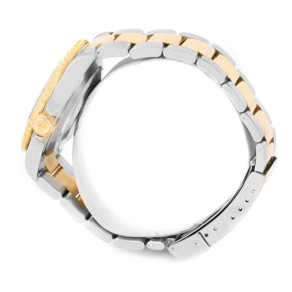 This image shows a side view of a Rolex Submariner 16613 Men's Steel and Gold (two tone) Blue Dial 16613 Men's Steel and Gold (two tone) Blue Dial, displaying its two-tone bracelet and crown.