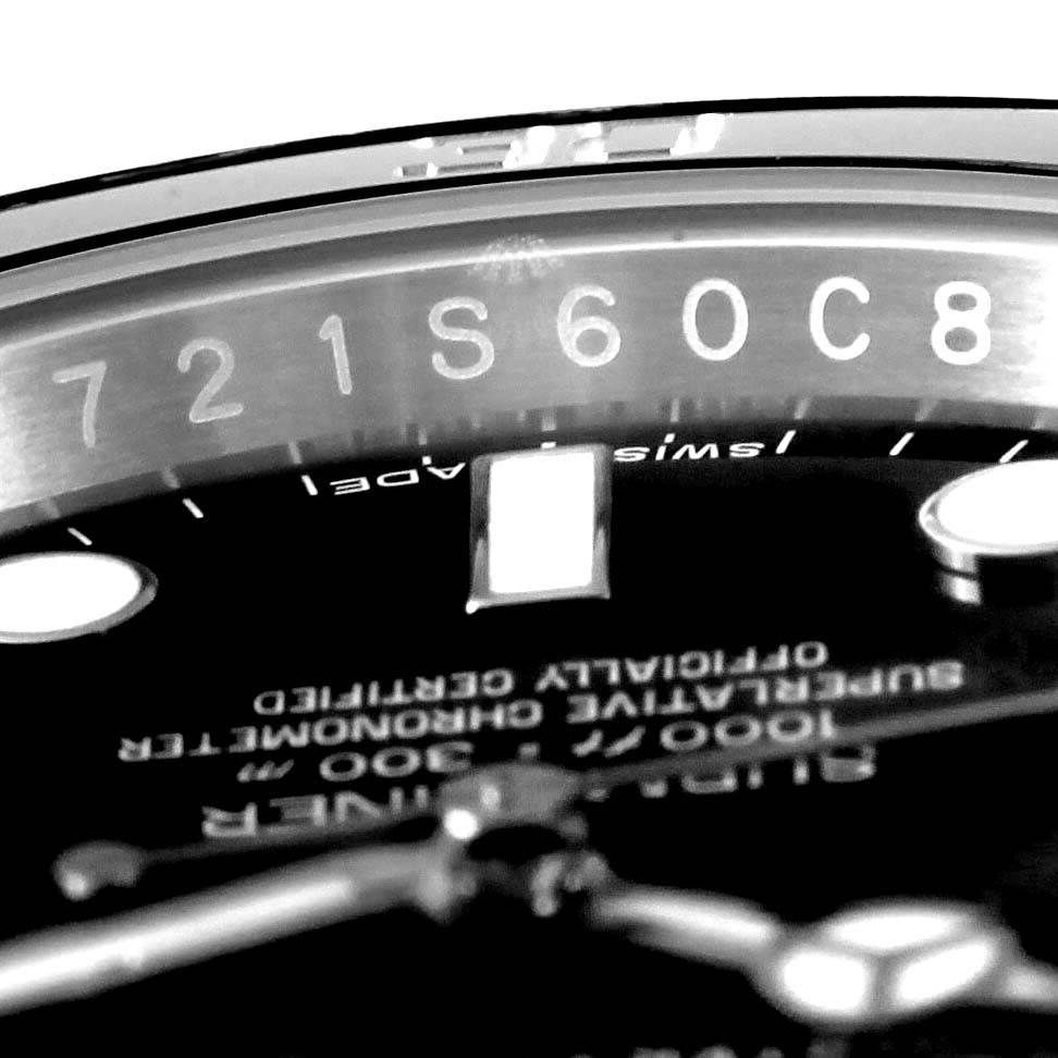 This close-up of the Rolex Submariner 114060 Men
s Stainless Steel Black Dial 114060 Men
s Stainless Steel Black Dial watch shows the inside chapter ring, serial number, and part of the dial.