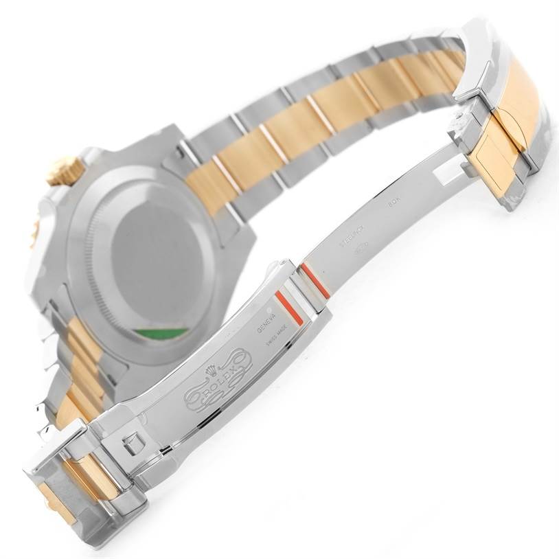 The image shows the underside of a Rolex Submariner 116613LN Men's Steel and Gold (two tone) Black Dial 116613LN Men's Steel and Gold (two tone) Black Dial watch, focusing on its metal bracelet and open clasp.