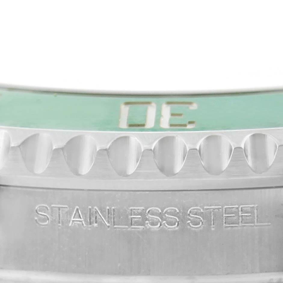 This close-up image shows the stainless steel case and edge of the green bezel of a Rolex Submariner 116610LV Men's Stainless Steel Green Dial 116610LV Men's Stainless Steel Green Dial watch.