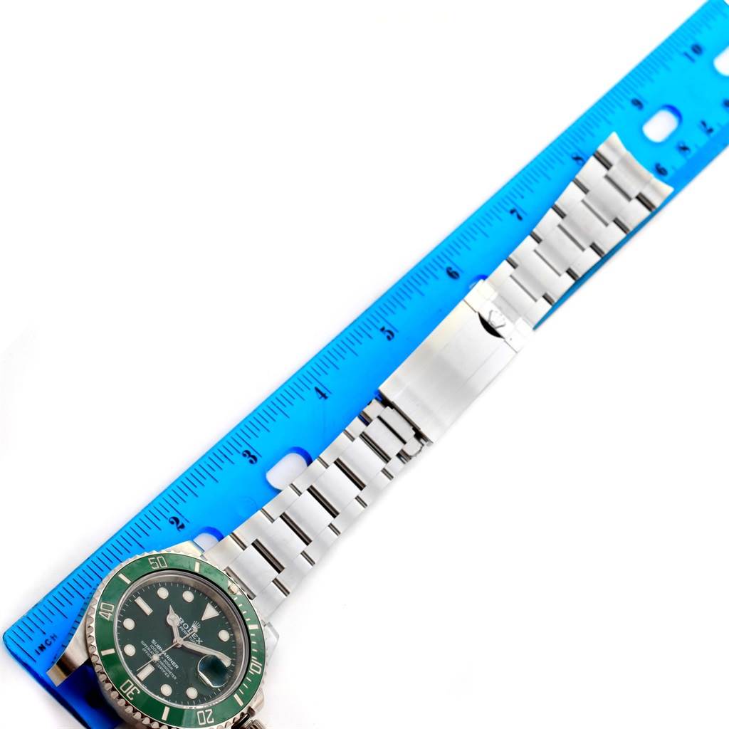 The image shows a Rolex Submariner 116610LV Men's Stainless Steel Green Dial 116610LV Men's Stainless Steel Green Dial watch, displaying the face and bracelet alongside a blue ruler for scale.