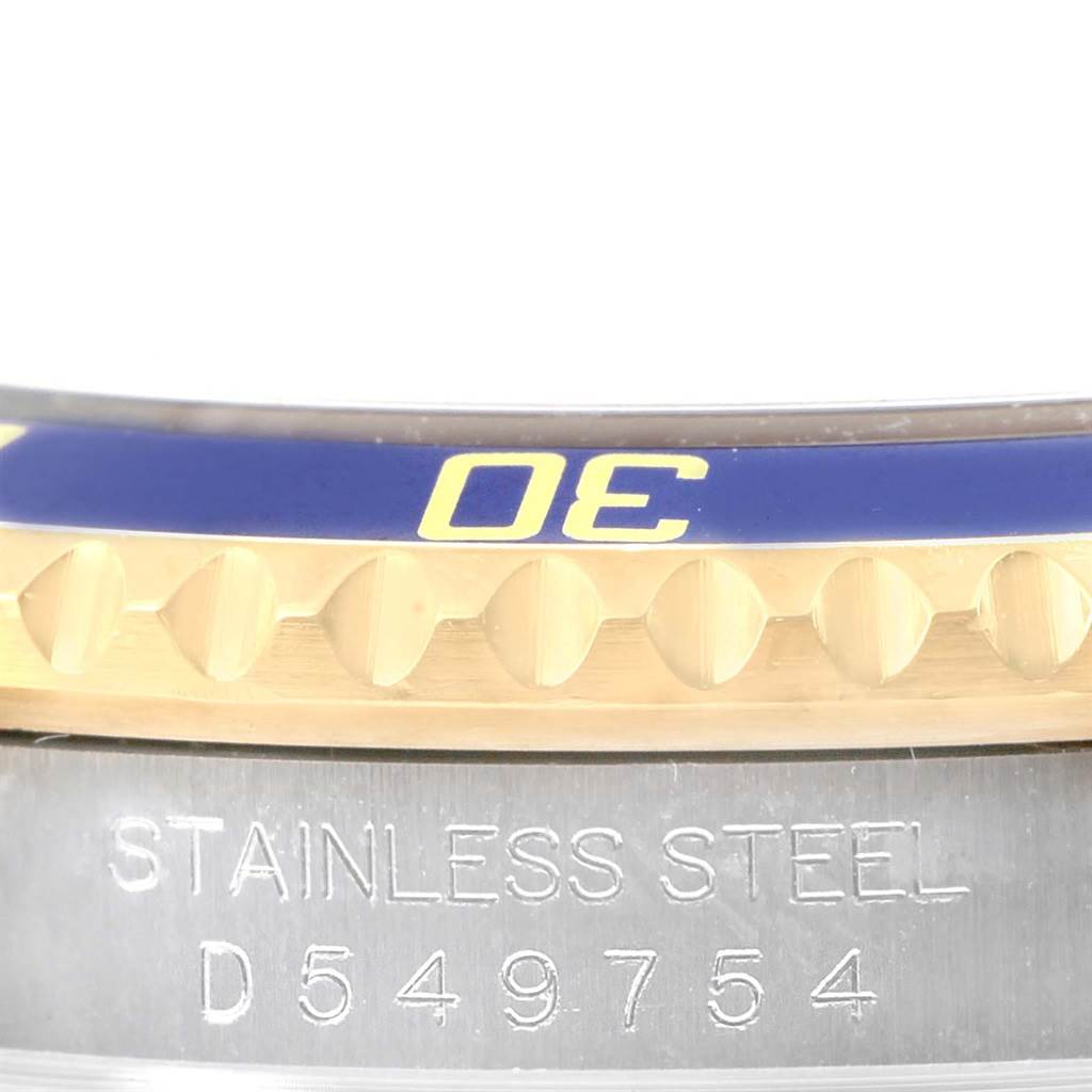 This image shows a close-up of the bezel and engraved case side of a Rolex Submariner 16613 Men's Steel and Gold (two tone) Champagne Dial 16613 Men's Steel and Gold (two tone) Champagne Dial watch.