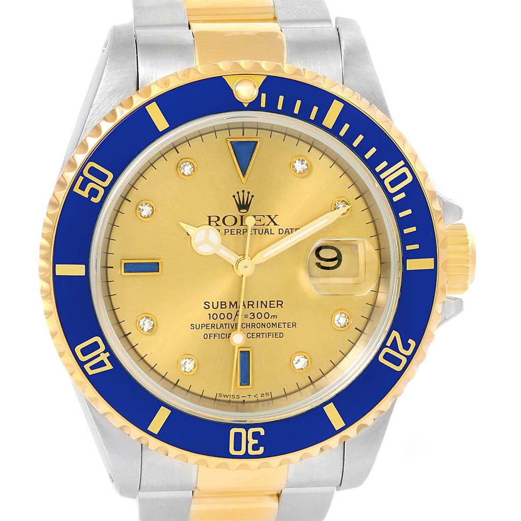 The image shows a frontal view of a Rolex Submariner 16613 Men's Steel and Gold (two tone) Champagne Dial 16613 Men's Steel and Gold (two tone) Champagne Dial watch with a blue bezel, gold dial, and two-tone bracelet.