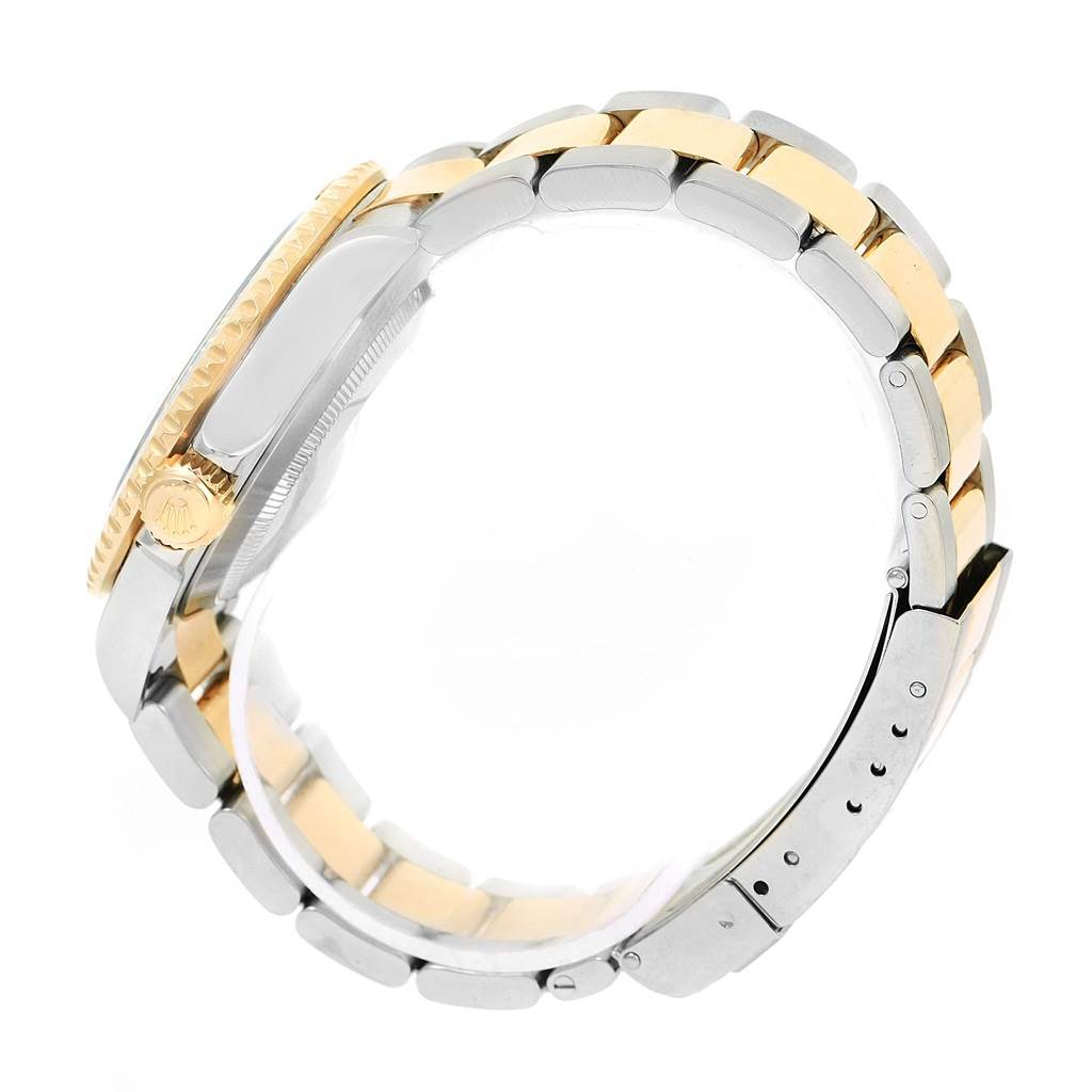 The image shows a side view of the Rolex Submariner 16613 Men's Steel and Gold (two tone) Champagne Dial 16613 Men's Steel and Gold (two tone) Champagne Dial, highlighting its two-tone bracelet and bezel edge.