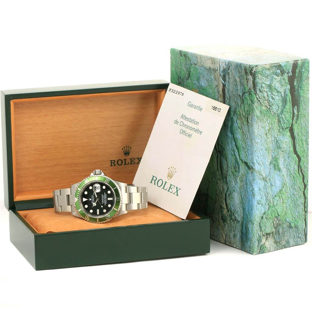 The image shows a Rolex Submariner 16610LV Men's Stainless Steel Black Dial 16610LV Men's Stainless Steel Black Dial watch in its box with an official certificate and the outer packaging in the background.