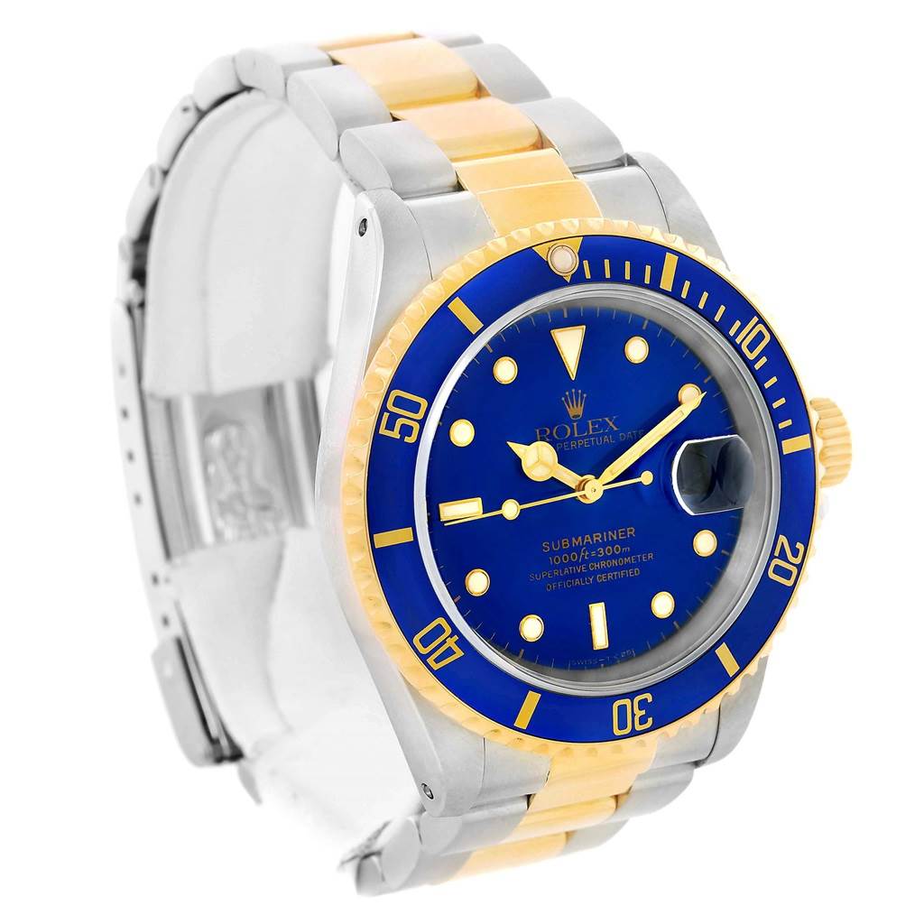 The Rolex Submariner 16613 Men's Steel and Gold (two tone) Blue Dial 16613 Men's Steel and Gold (two tone) Blue Dial watch is shown at a three-quarter angle, highlighting its blue dial, bezel, and two-tone bracelet.