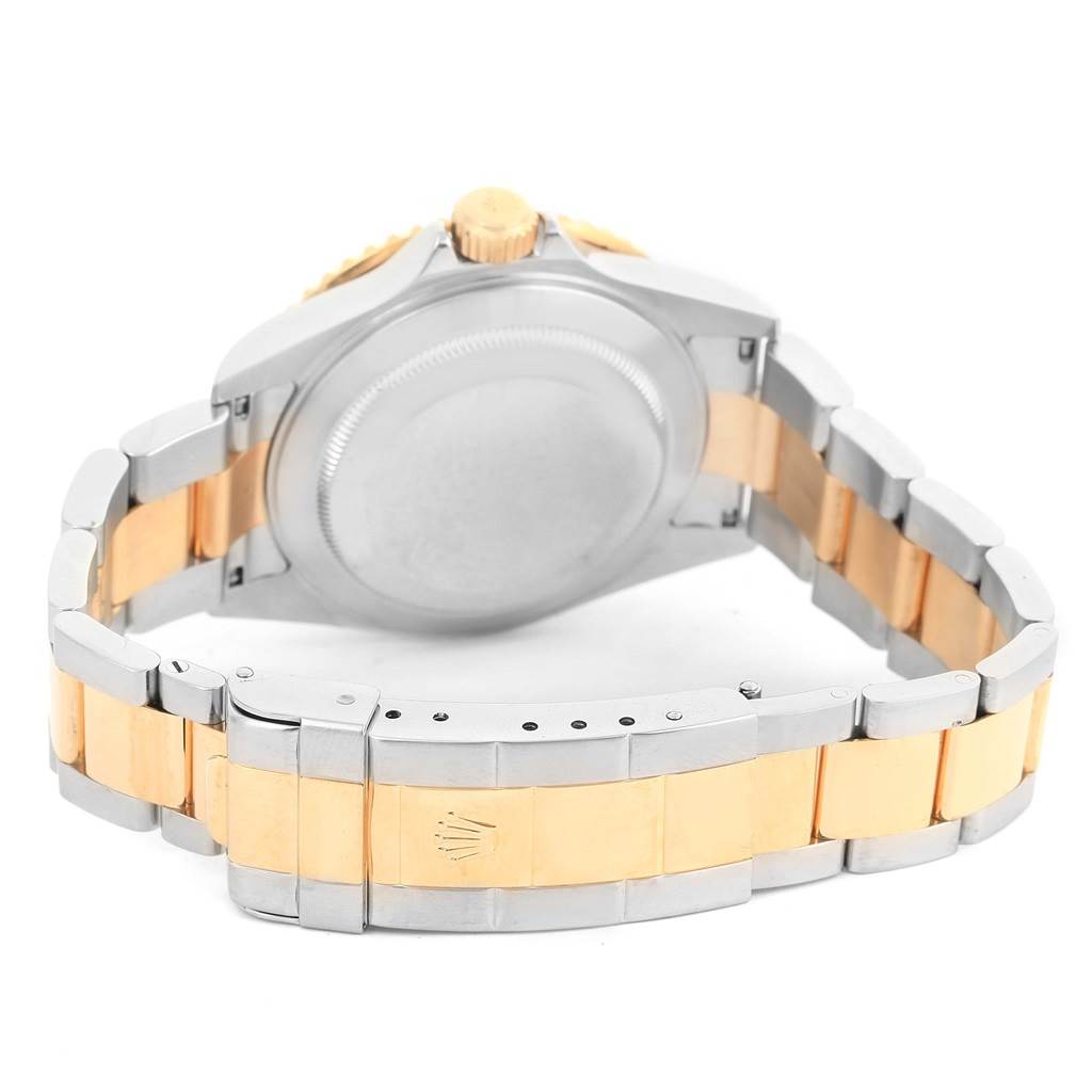 This image shows the back case and bracelet of a Rolex Submariner 16613 Men's Steel and Gold (two tone) Black Dial 16613 Men's Steel and Gold (two tone) Black Dial watch, viewed from an angle showcasing the clasp and crown.