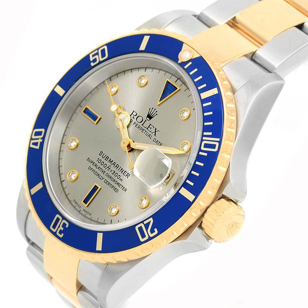 The image shows a close-up angled side view of a Rolex Submariner 16613 Men's Steel and Gold (two tone) Grey Dial 16613 Men's Steel and Gold (two tone) Grey Dial watch, highlighting the dial, bezel, and part of the bracelet.