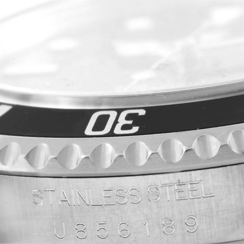 This image shows a close-up of the bezel and engraved stainless steel caseback of a Rolex Submariner 14060 Men's Stainless Steel Black Dial 14060 Men's Stainless Steel Black Dial watch.