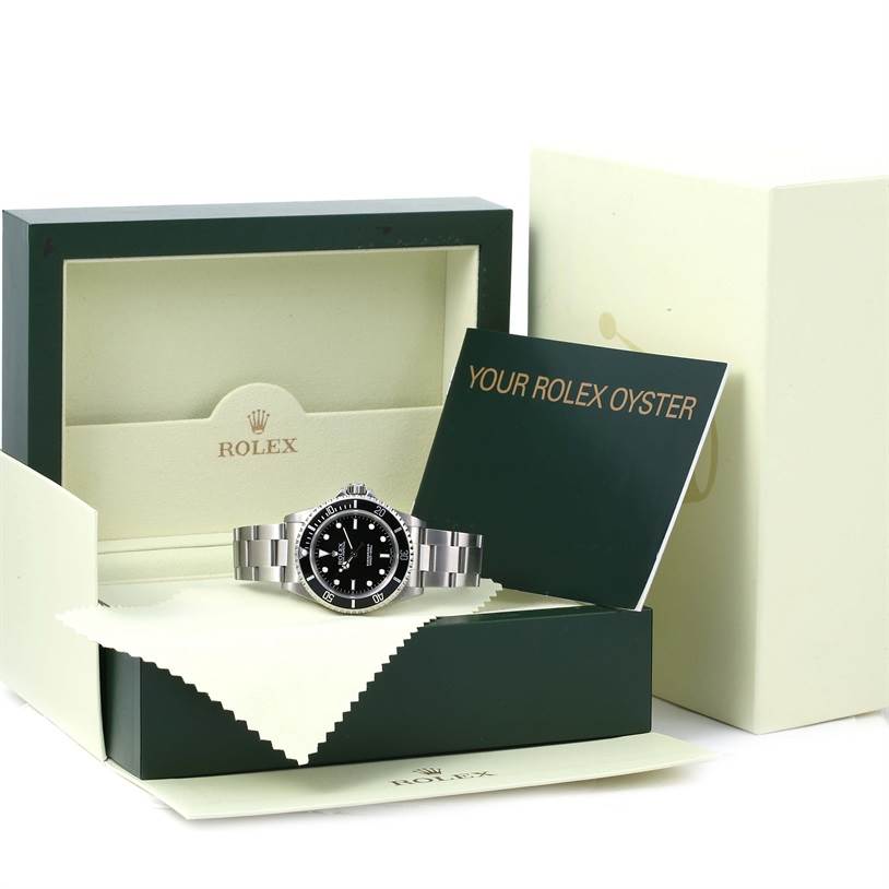 This image shows a Rolex Submariner 14060 Men's Stainless Steel Black Dial 14060 Men's Stainless Steel Black Dial watch in its box with a booklet and cleaning cloth visible.