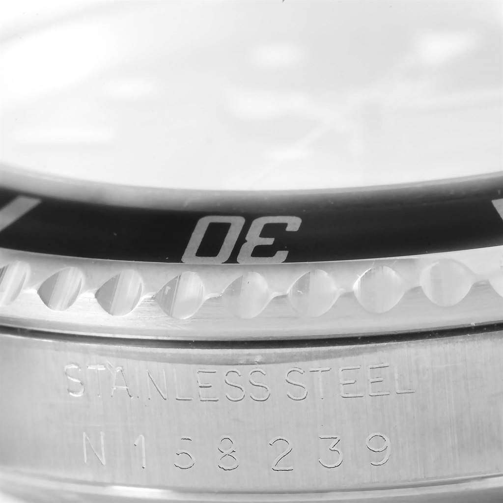 The image shows a close-up of the bezel and case of a Rolex Submariner 14060 Men's Stainless Steel Black Dial 14060 Men's Stainless Steel Black Dial watch, highlighting the stainless steel engraving.