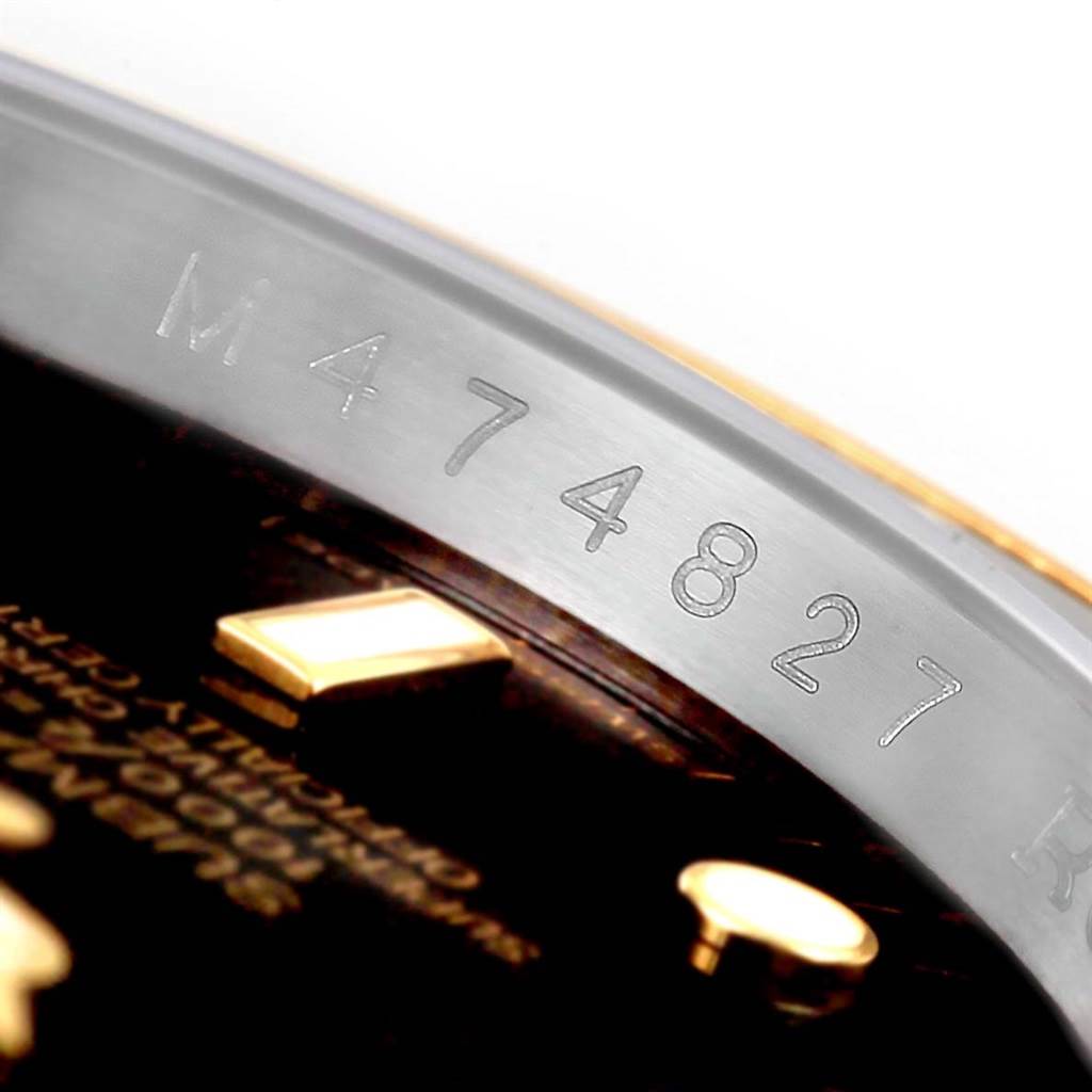 This close-up image shows the serial number engraving on the inner bezel (rehaut) of a Rolex Submariner 16613 Men's Steel and Gold (two tone) Black Dial 16613 Men's Steel and Gold (two tone) Black Dial watch.