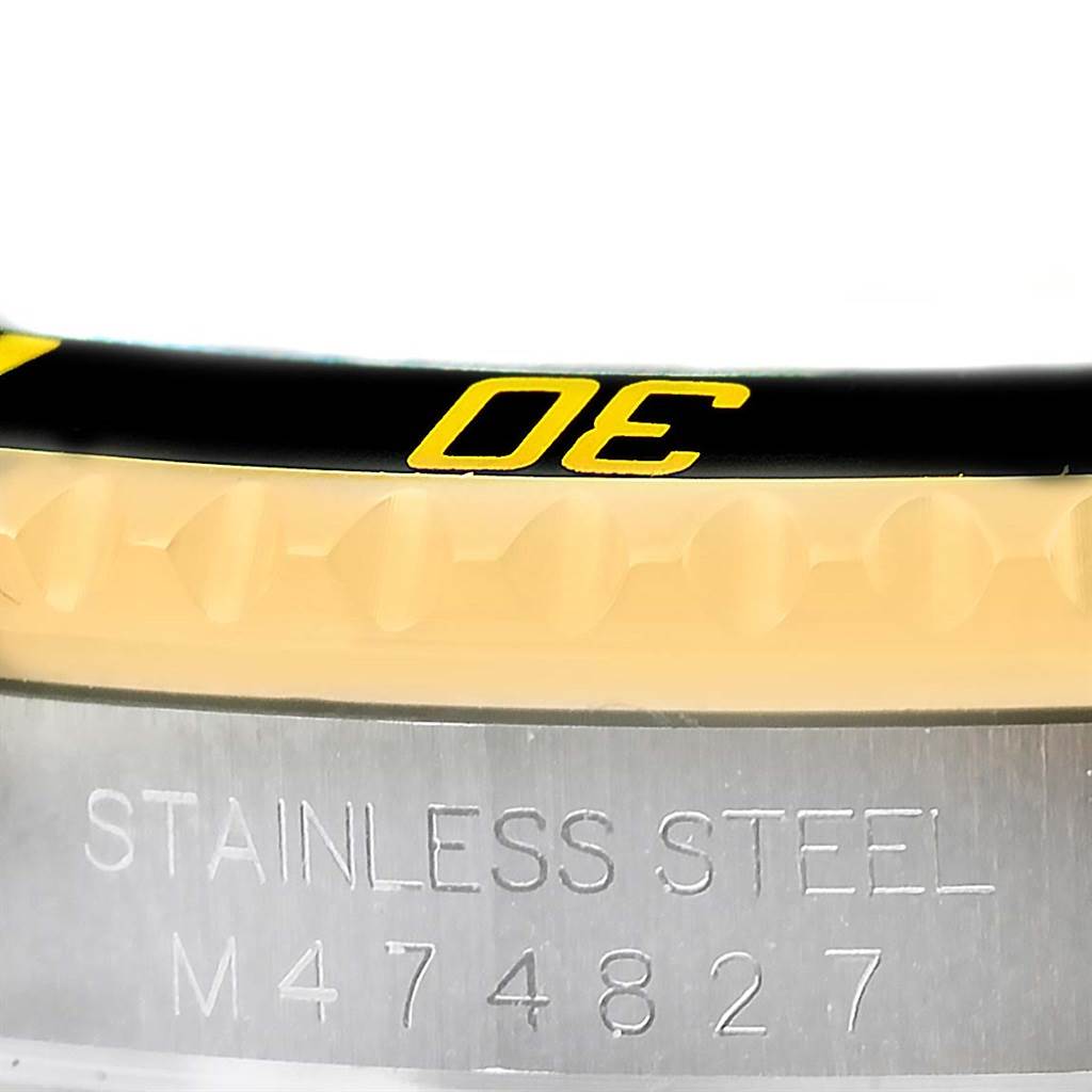 The image shows a close-up of the bezel and case serial number of a Rolex Submariner 16613 Men's Steel and Gold (two tone) Black Dial 16613 Men's Steel and Gold (two tone) Black Dial watch.