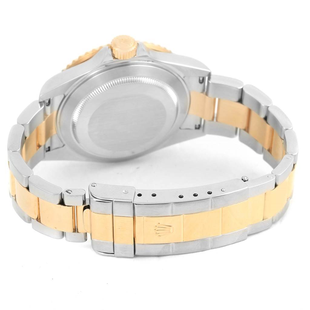 The image shows the back view of the Rolex Submariner 16613 Men's Steel and Gold (two tone) Blue Dial 16613 Men's Steel and Gold (two tone) Blue Dial, highlighting the case back, crown, and bi-color bracelet.