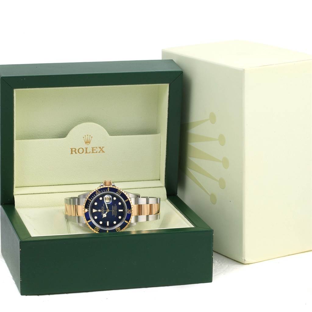 The image shows a Rolex Submariner 16613 Men's Steel and Gold (two tone) Blue Dial 16613 Men's Steel and Gold (two tone) Blue Dial watch in its open box, viewed from the front angle.