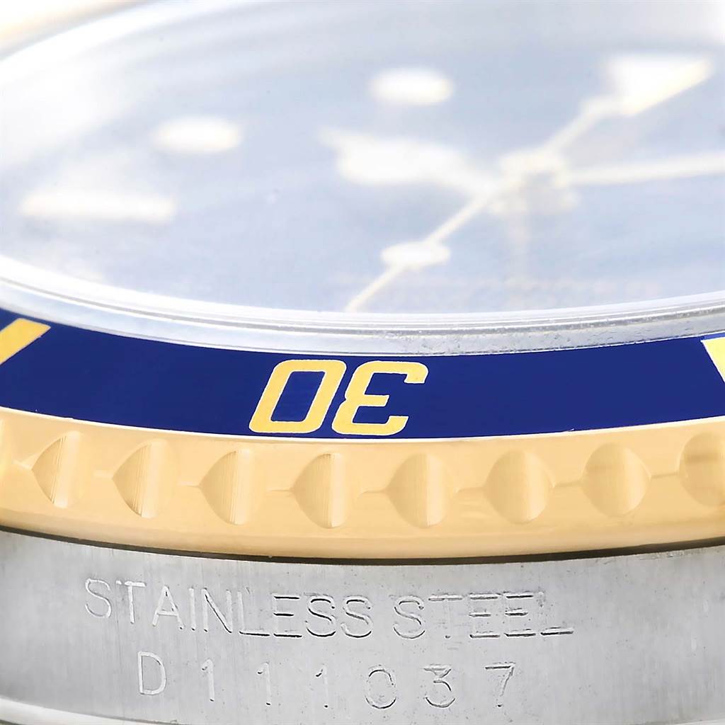 This close-up image shows the side view of the bezel and case of a Rolex Submariner 16613 Men's Steel and Gold (two tone) Blue Dial 16613 Men's Steel and Gold (two tone) Blue Dial watch.