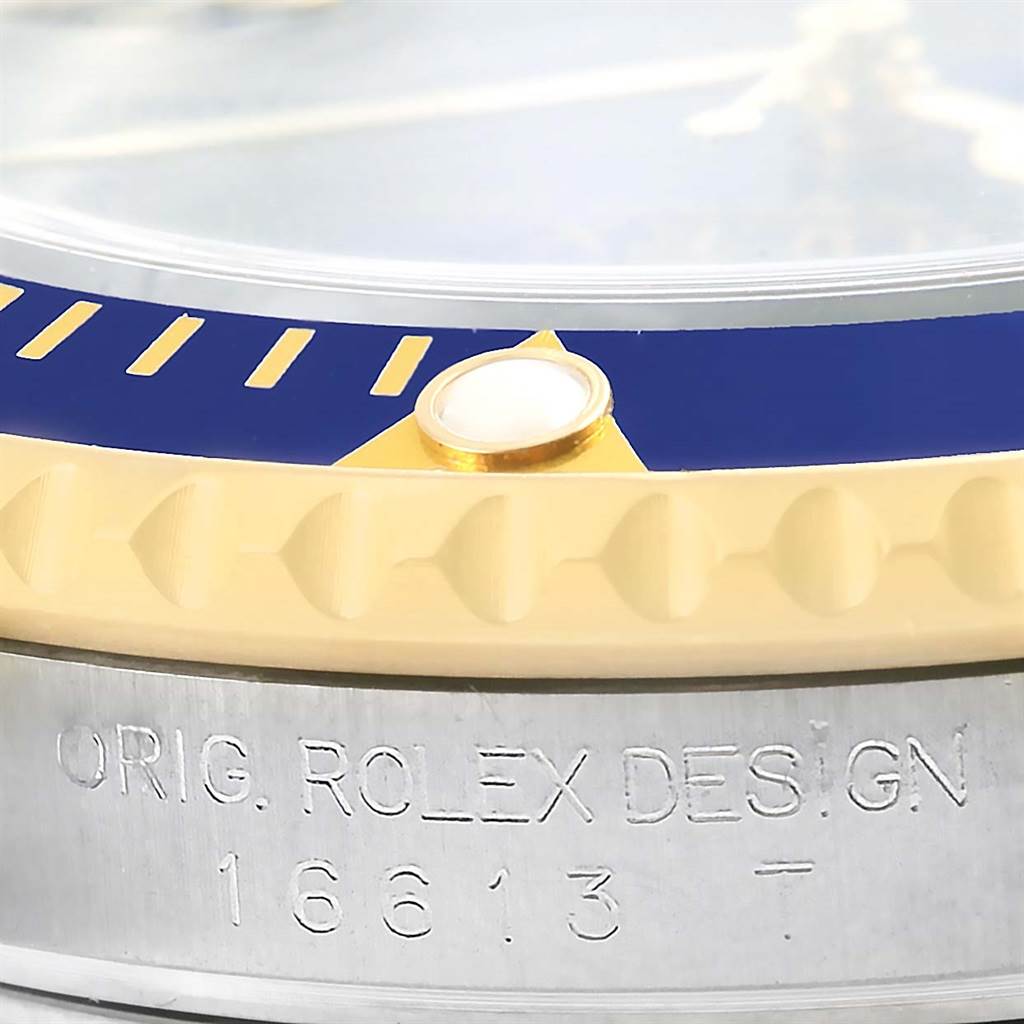 The image shows a close-up of the bezel and case edge of a Rolex Submariner 16613 Men's Steel and Gold (two tone) Blue Dial 16613 Men's Steel and Gold (two tone) Blue Dial 16613 watch.