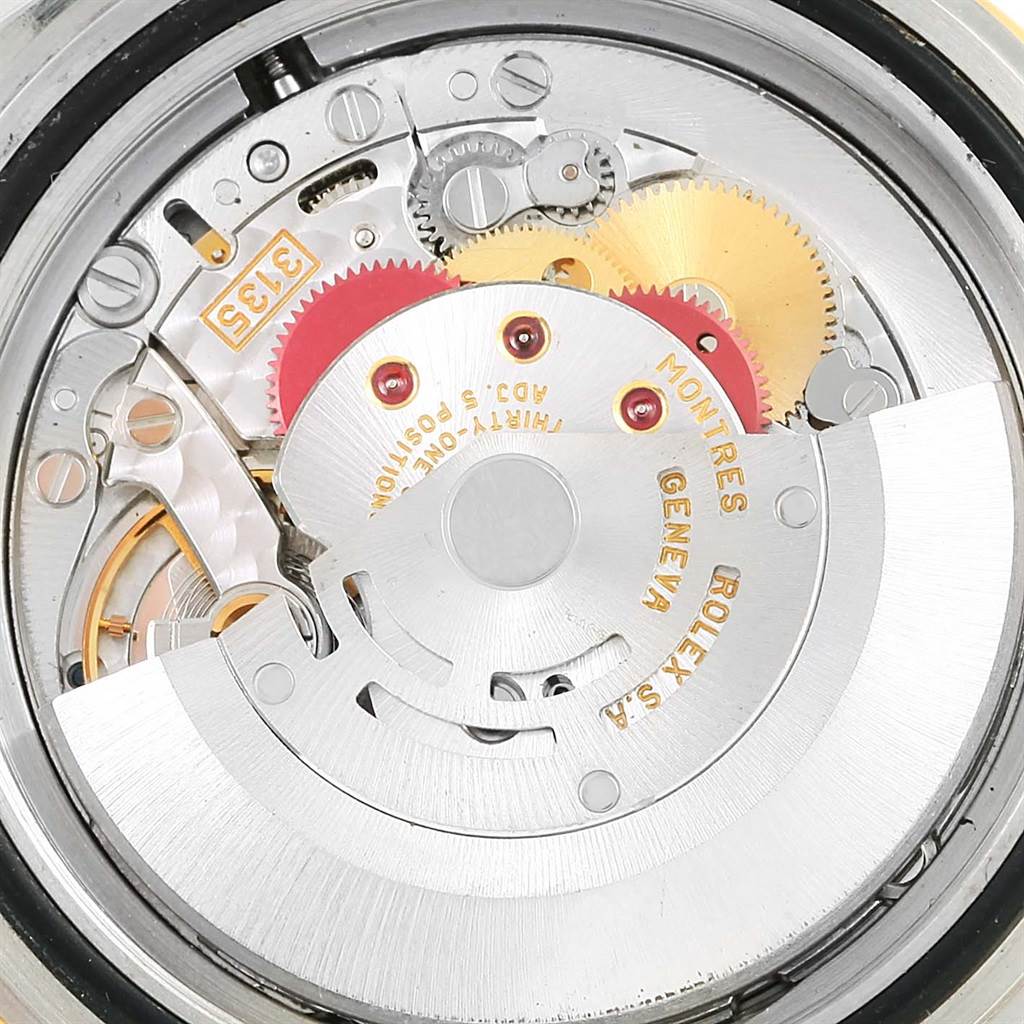 This image shows the internal mechanical movement of a Rolex Submariner 16613 Men's Steel and Gold (two tone) Champagne Dial 16613 Men's Steel and Gold (two tone) Champagne Dial watch, highlighting its gears and rotor.