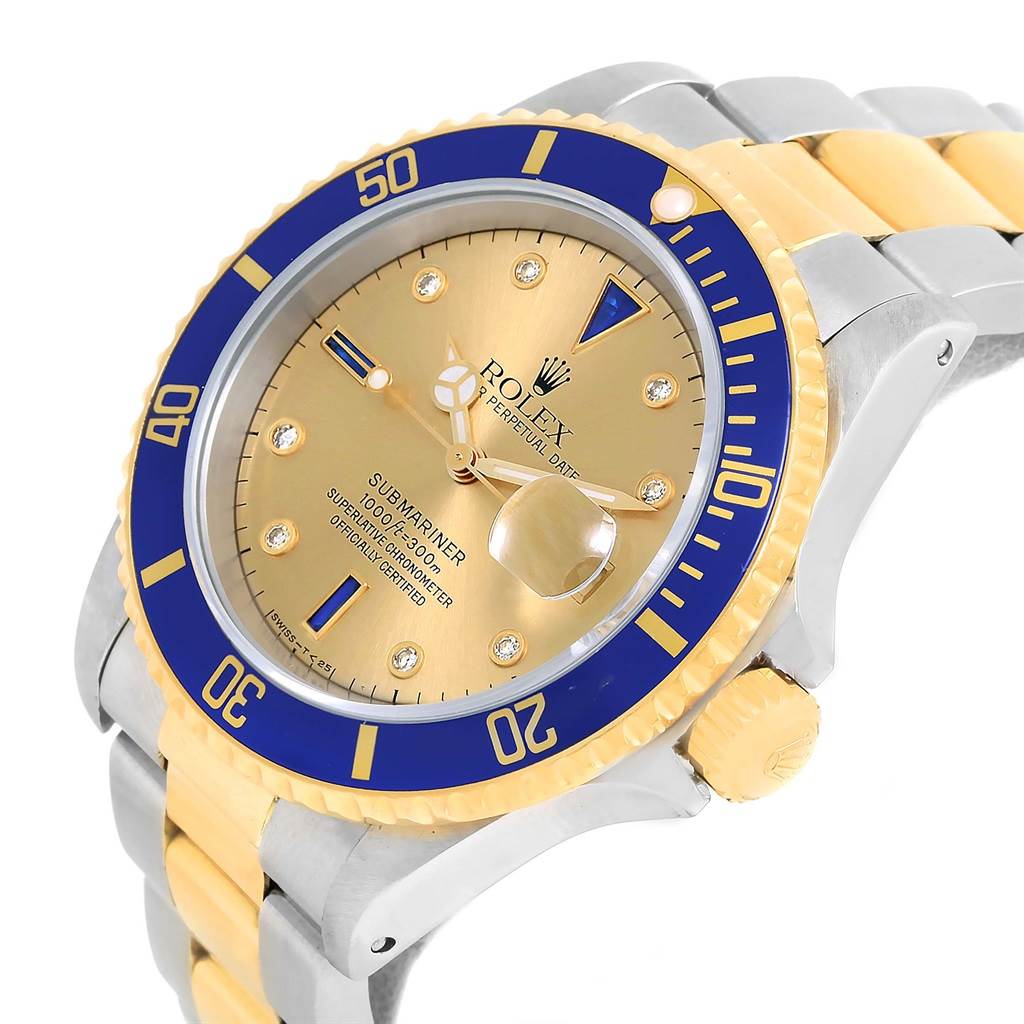 The Rolex Submariner 16613 Men's Steel and Gold (two tone) Champagne Dial 16613 Men's Steel and Gold (two tone) Champagne Dial watch is shown at a slight angle, highlighting the gold dial, blue bezel, and two-tone bracelet.