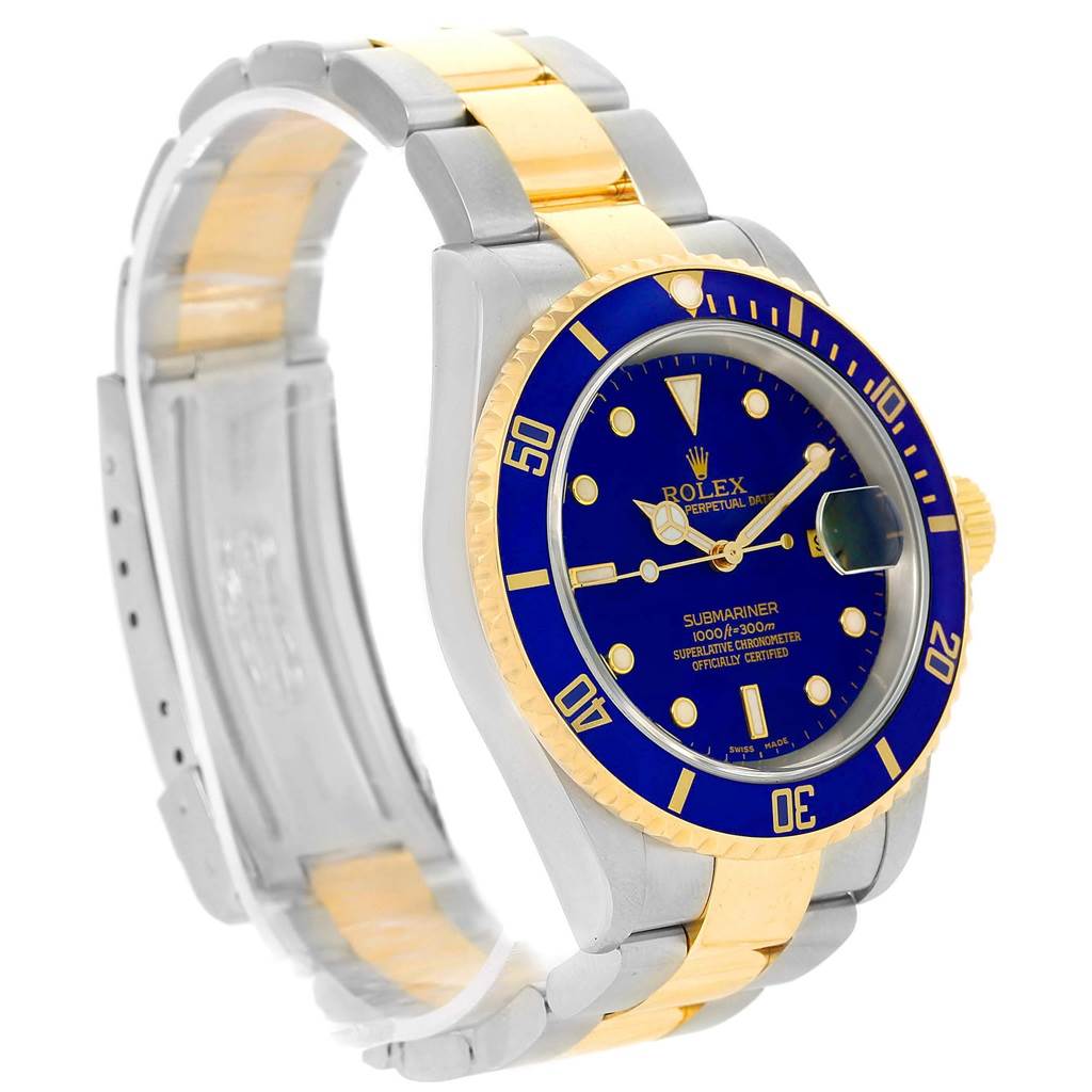 The image shows a Rolex Submariner 16613 Men's Steel and Gold (two tone) Blue Dial 16613 Men's Steel and Gold (two tone) Blue Dial watch at an angle highlighting its face, bezel, and two-tone bracelet.
