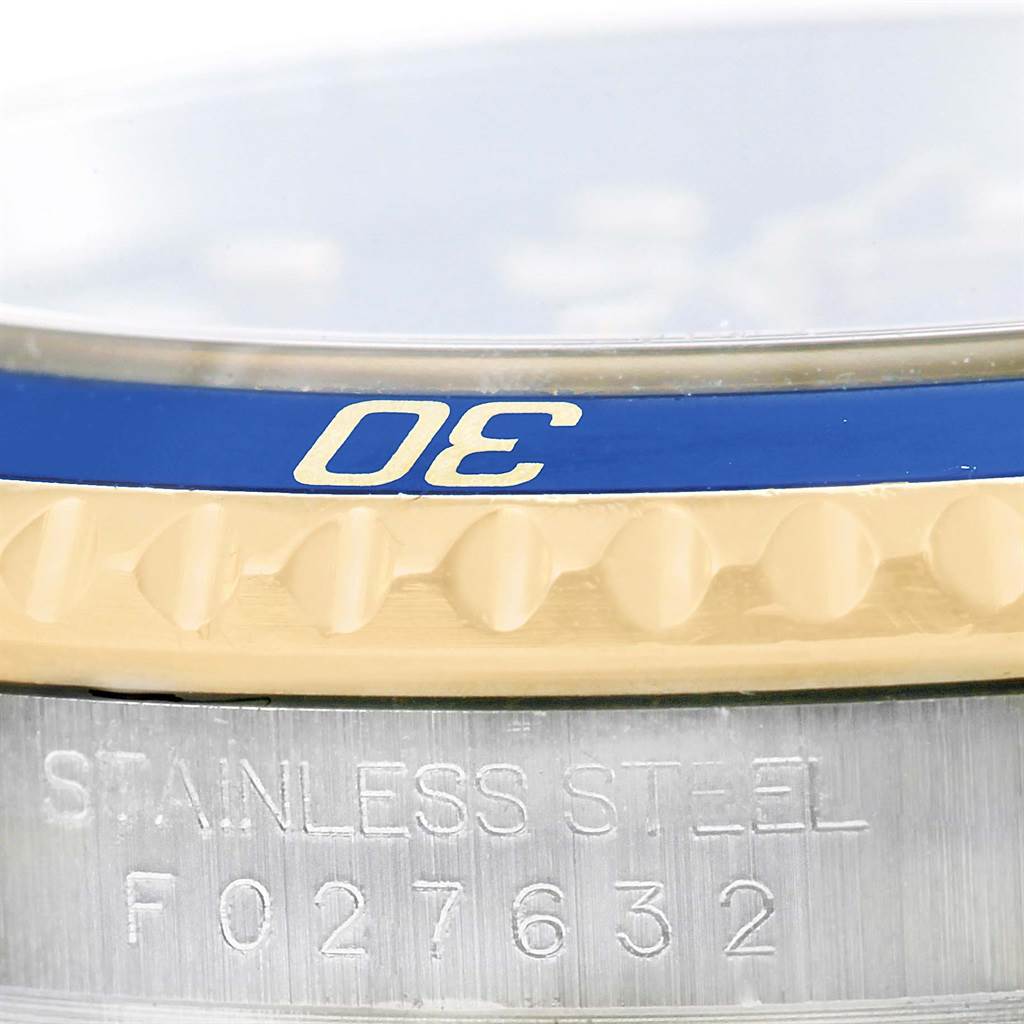 Close-up angle of the Rolex Submariner 16613 Men's Steel and Gold (two tone) Blue Dial 16613 Men's Steel and Gold (two tone) Blue Dial's bezel, focusing on the "30" marker and the stainless steel case with serial number.