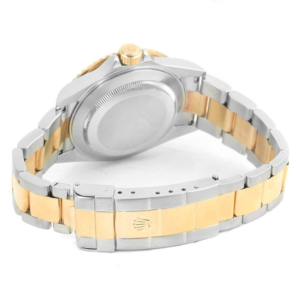 The image shows the back and bracelet of a Rolex Submariner 16613 Men's Steel and Gold (two tone) Blue Dial 16613 Men's Steel and Gold (two tone) Blue Dial watch, highlighting the two-tone metal design and clasp.