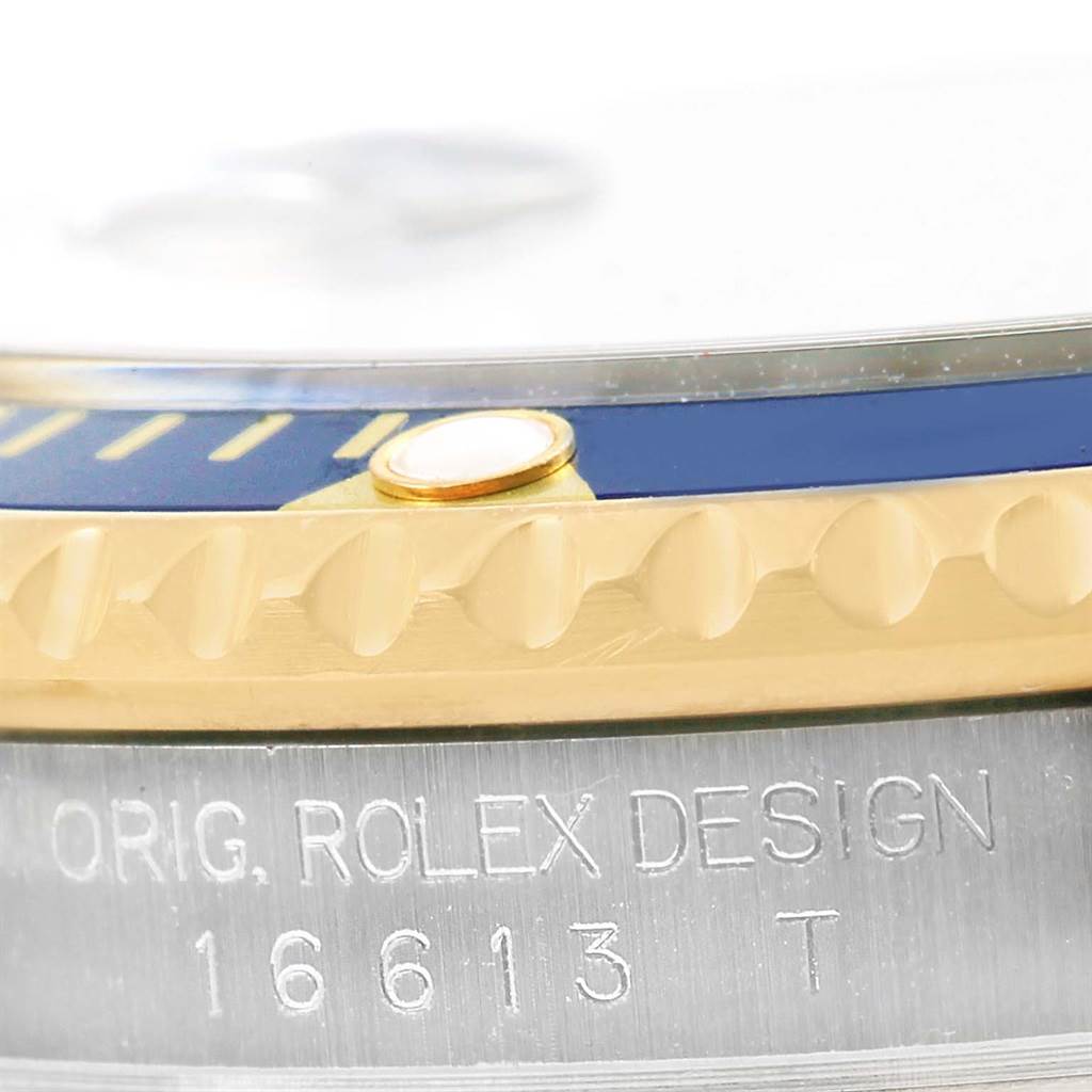 The image shows a close-up of the bezel and case edge of a Rolex Submariner 16613 Men's Steel and Gold (two tone) Blue Dial 16613 Men's Steel and Gold (two tone) Blue Dial watch, revealing the "ORIG. ROLEX DESIGN" engraving and model number 16613.