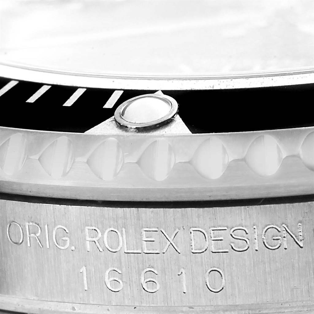 This is a close-up view of the bezel and case engraving of a Rolex Submariner 16610 Men's Stainless Steel Black Dial 16610 Men's Stainless Steel Black Dial model 16610.