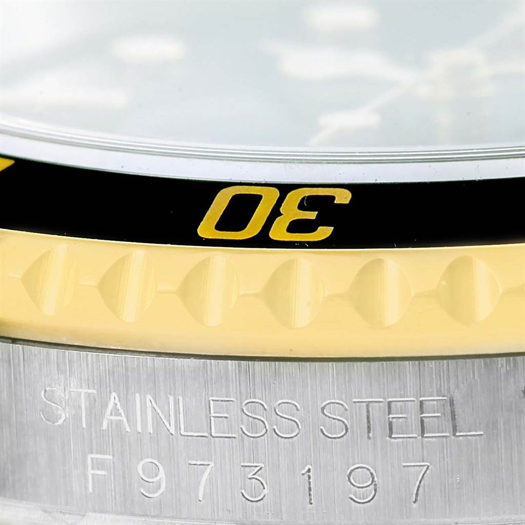 This image shows a close-up of the bezel with the number "30" and the engraved case side of the Rolex Submariner 16613 Men's Steel and Gold (two tone) Black Dial 16613 Men's Steel and Gold (two tone) Black Dial watch.