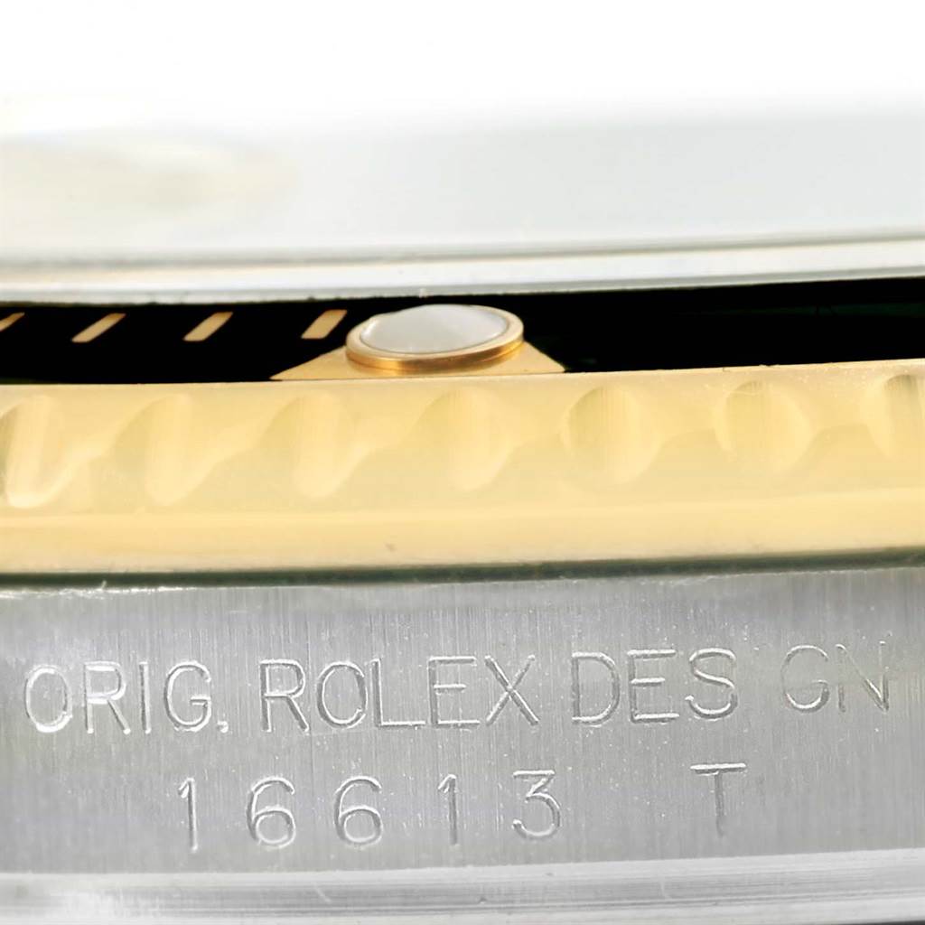 This close-up image shows the side engraving, bezel, and case details of the Rolex Submariner 16613 Men's Steel and Gold (two tone) Champagne Dial 16613 Men's Steel and Gold (two tone) Champagne Dial model 16613.