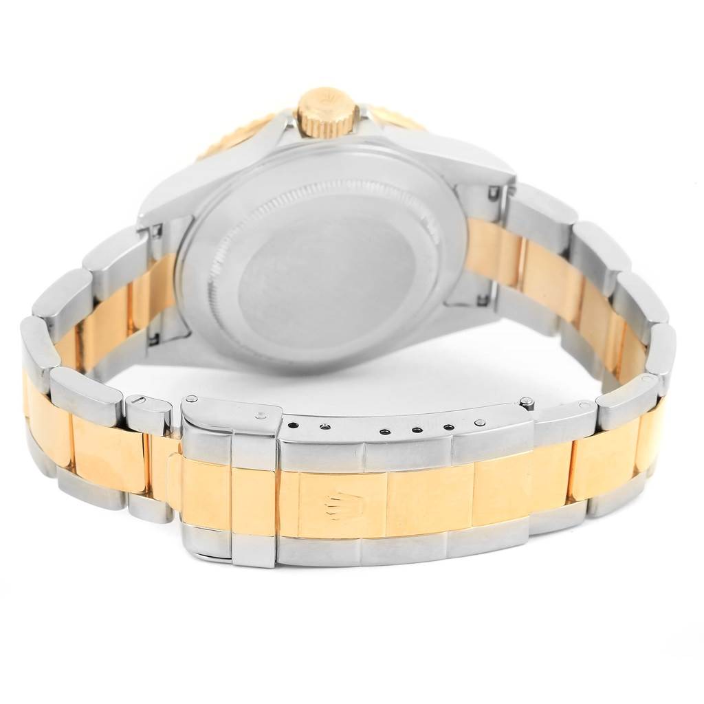 A rear view of the Rolex Submariner 16613 Men's Steel and Gold (two tone) Champagne Dial 16613 Men's Steel and Gold (two tone) Champagne Dial showing the case back, crown, and two-tone bracelet with clasp.