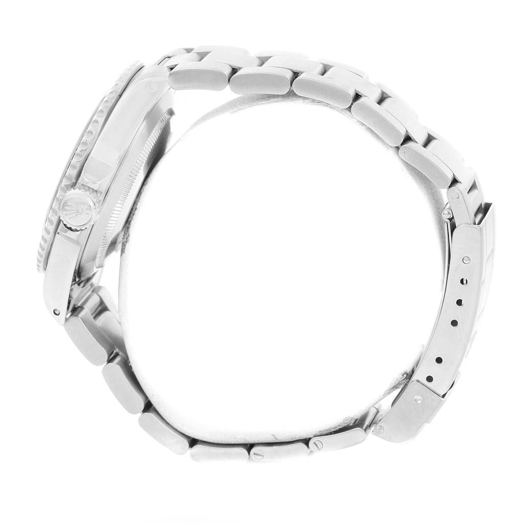 This side view of a Rolex Submariner 14060 Men's Stainless Steel Black Dial 14060 Men's Stainless Steel Black Dial watch shows the case, crown, and bracelet.