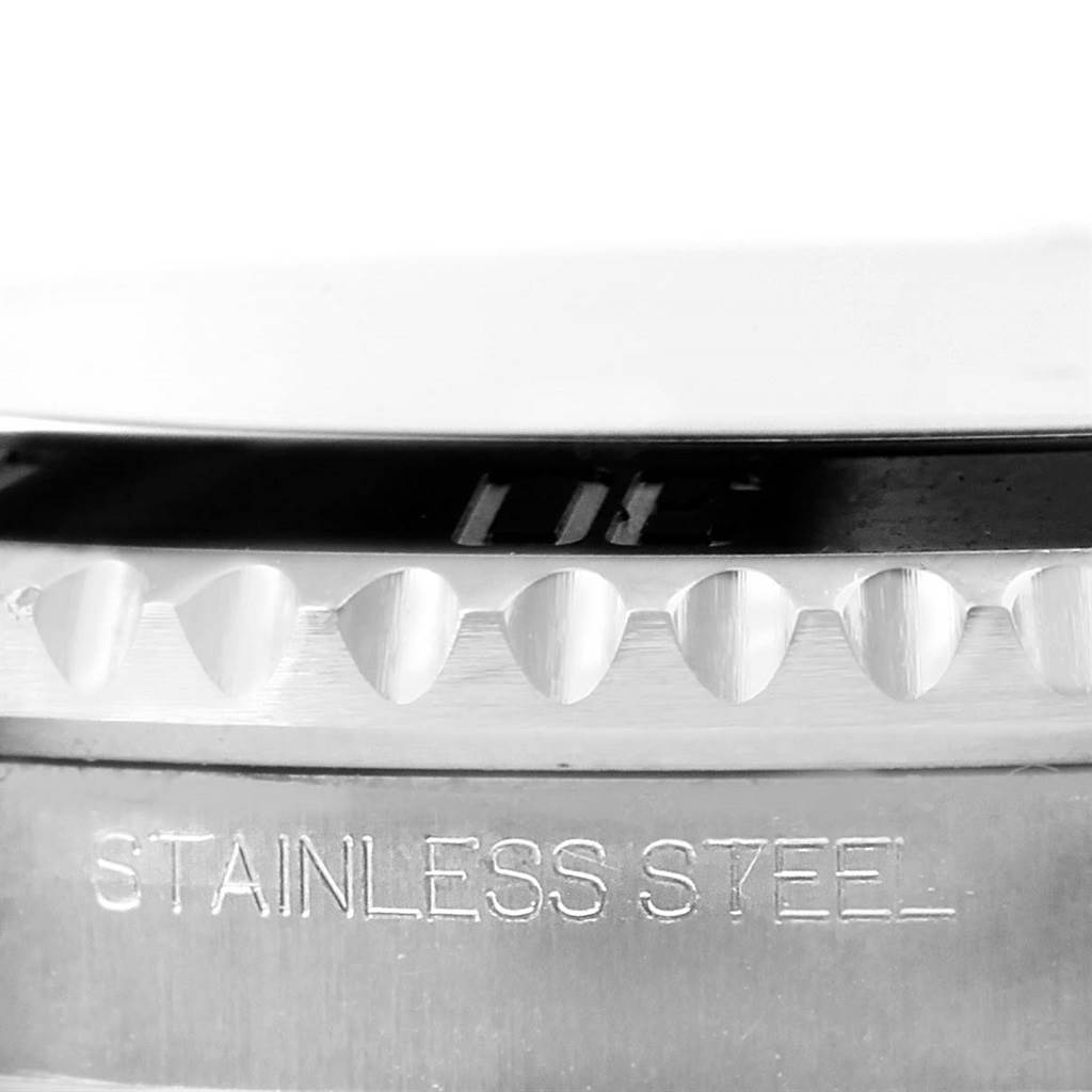 The image shows a close-up angle of the bezel and case of a Rolex Submariner 116610 Men's Stainless Steel Black Dial 116610 Men's Stainless Steel Black Dial, highlighting its "STAINLESS STEEL" engraving.