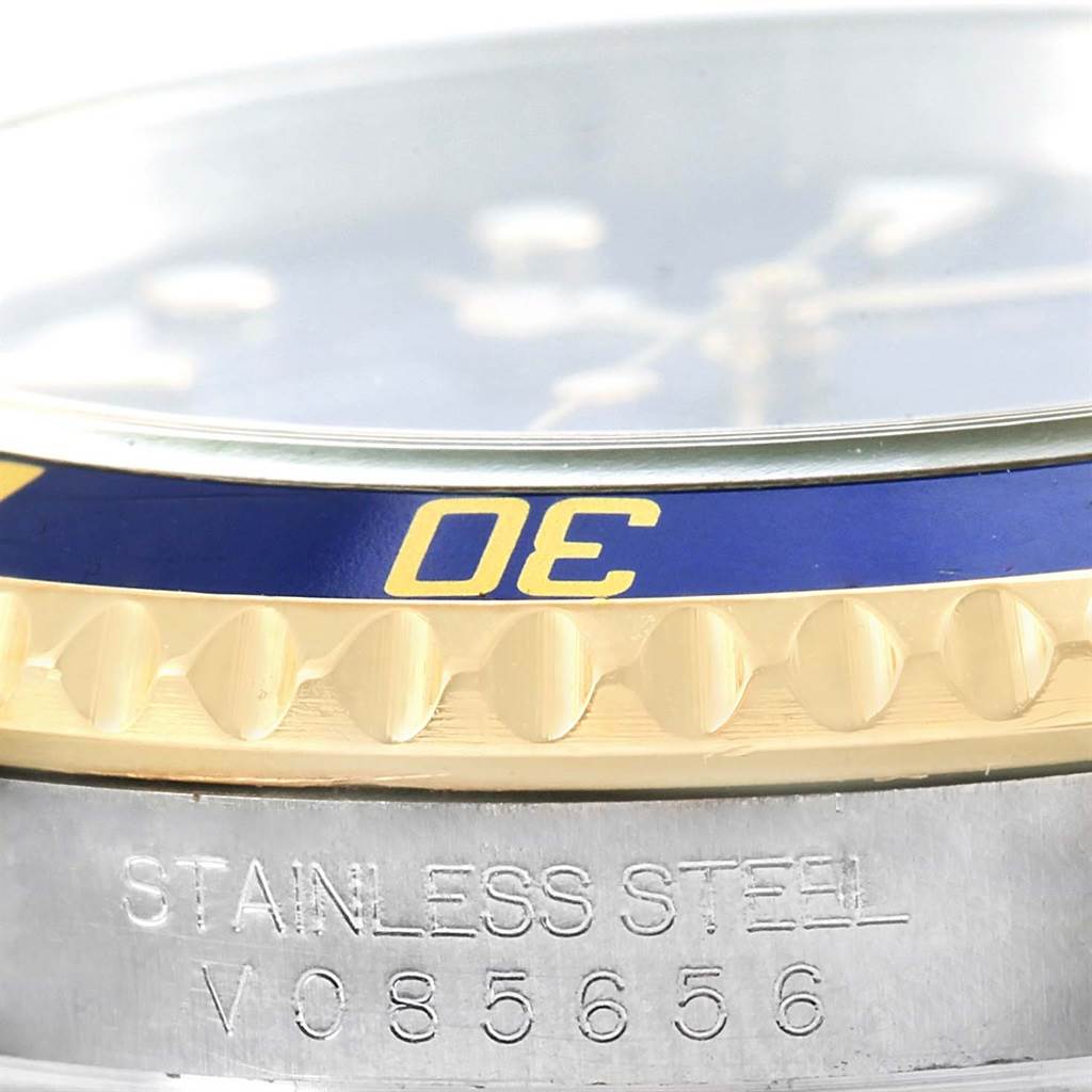 This image shows a close-up of the bezel and part of the case of a Rolex Submariner 16613 Men
s Steel and Gold (two tone) Blue Dial 16613 Men
s Steel and Gold (two tone) Blue Dial watch.