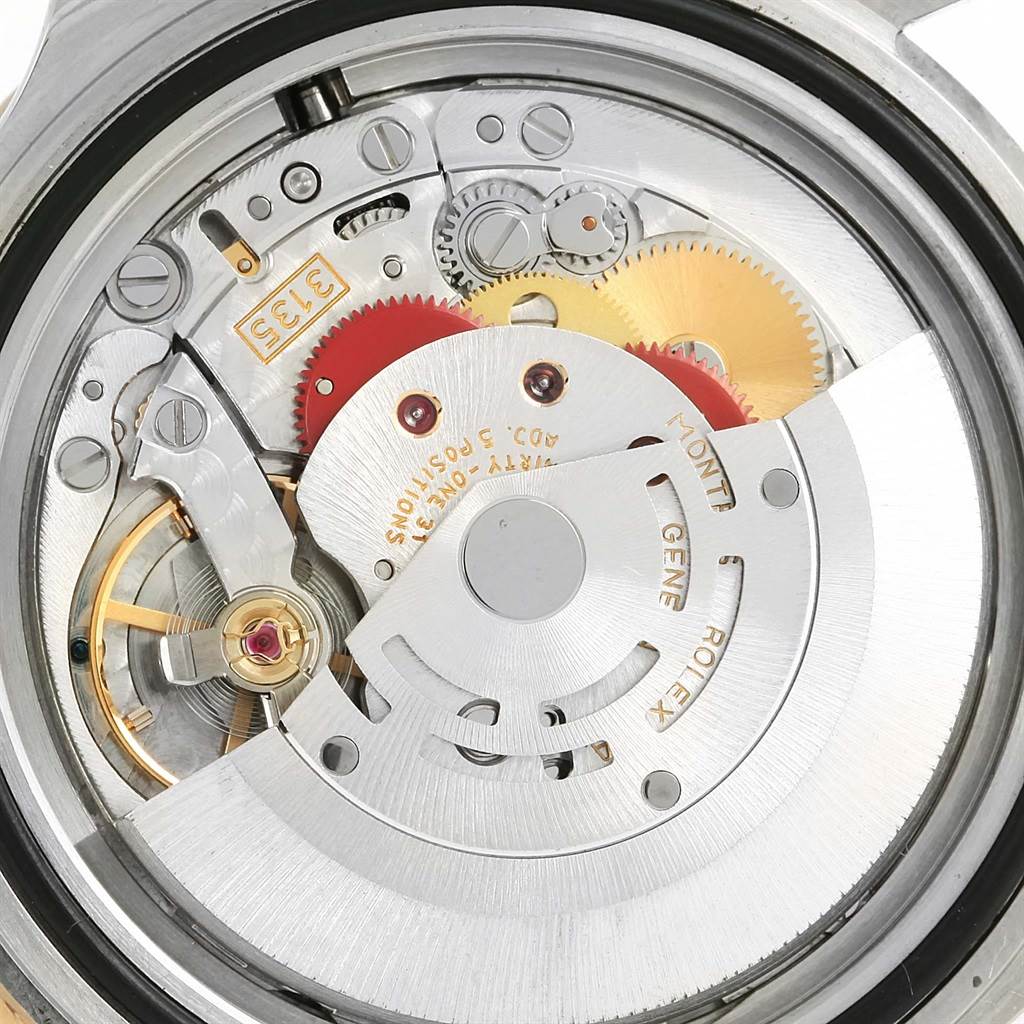 This image shows the internal mechanism and components of a Rolex Submariner 16613 Men
s Steel and Gold (two tone) Blue Dial 16613 Men
s Steel and Gold (two tone) Blue Dial watch from the back angle.