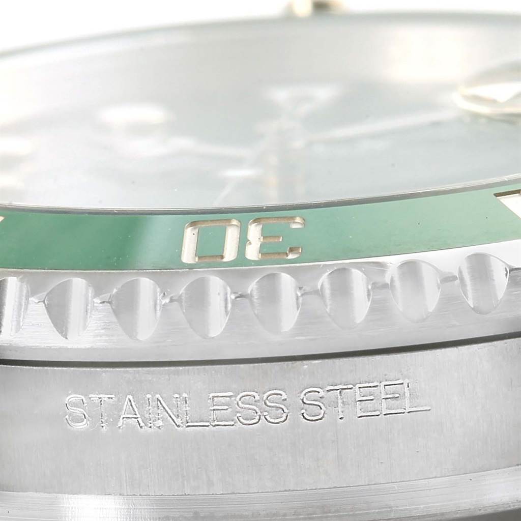 Close-up side view of the bezel and case of a Rolex Submariner 116610LV Men
s Stainless Steel Green Dial 116610LV Men
s Stainless Steel Green Dial, highlighting the green bezel and "STAINLESS STEEL" engraving.