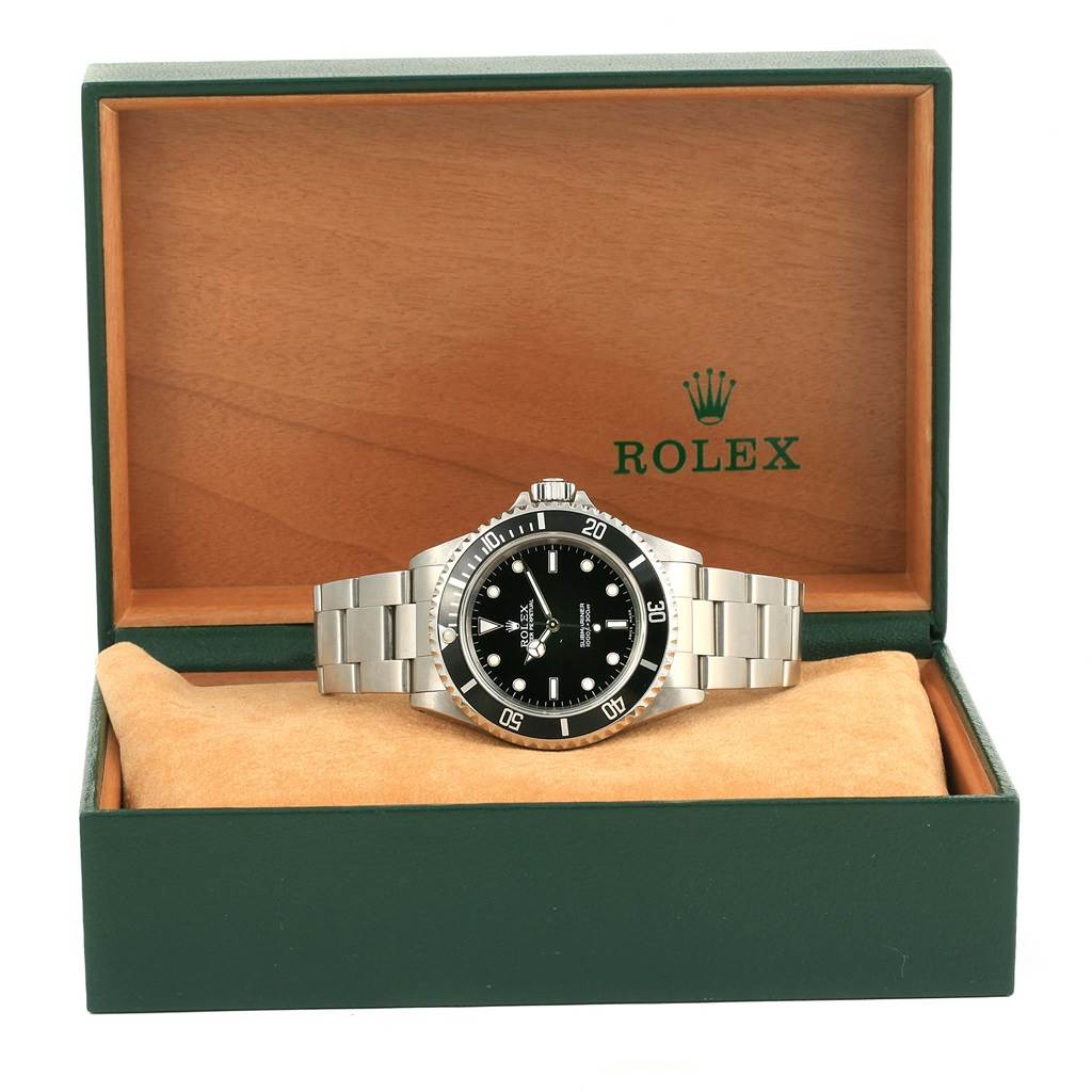 The image shows a front angle view of a Rolex Submariner 14060 Men
s Stainless Steel Black Dial 14060 Men
s Stainless Steel Black Dial watch, including the dial, bezel, and bracelet housed in its original green box.