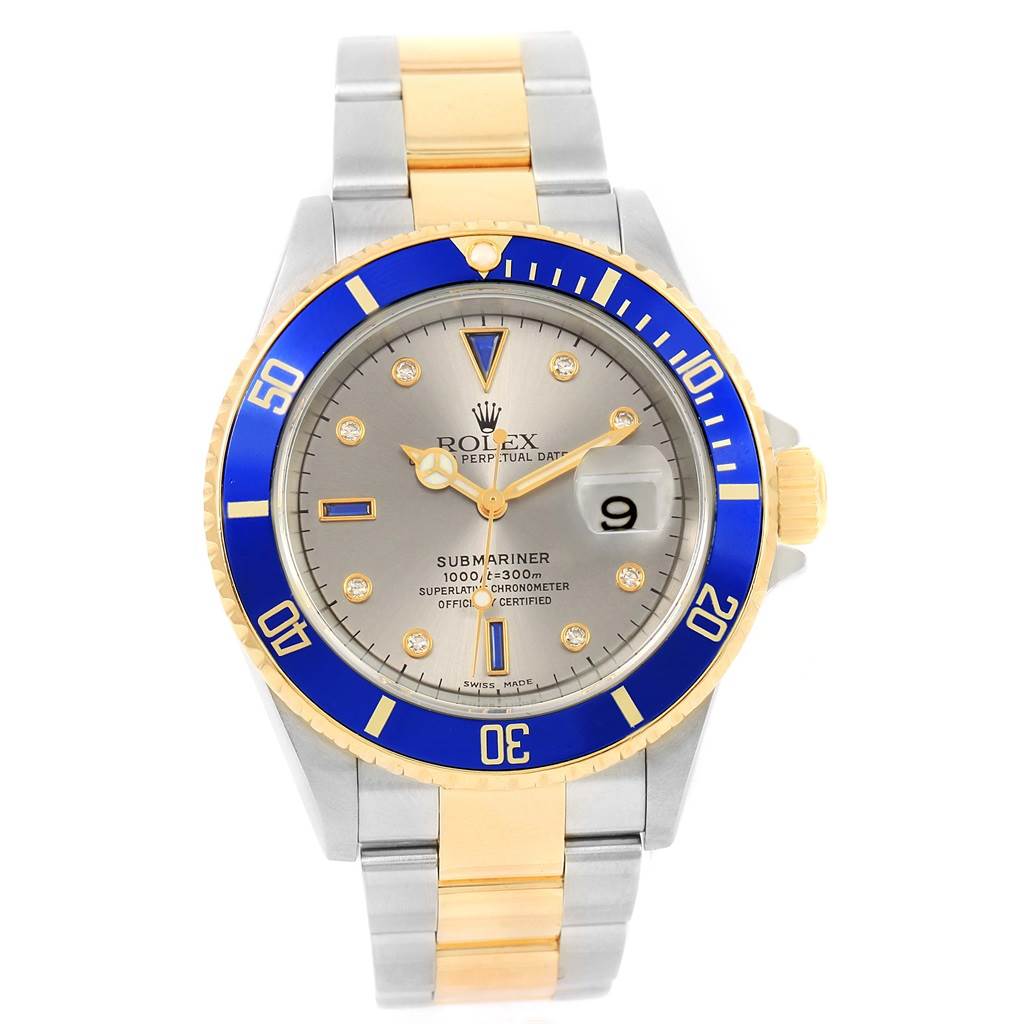 The image shows a Rolex Submariner 16613 Men's Steel and Gold (two tone) Grey Dial 16613 Men's Steel and Gold (two tone) Grey Dial watch from a front angle, highlighting its blue bezel and two-tone metal bracelet.
