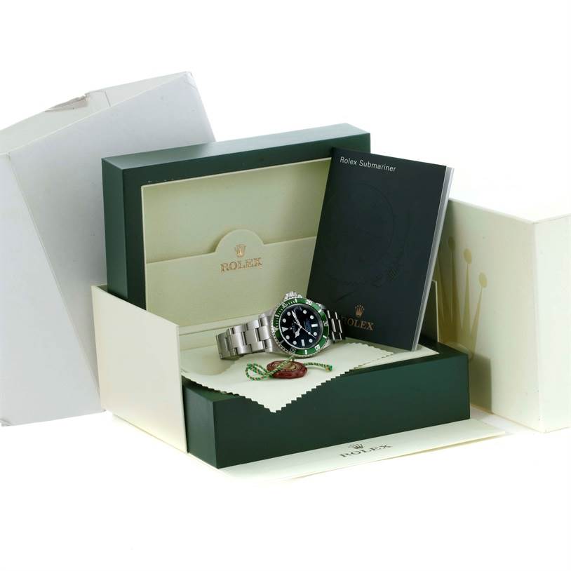 The image shows a Rolex Submariner 16610LV Men
s Stainless Steel Black Dial 16610LV Men
s Stainless Steel Black Dial watch with its box, instruction booklet, and accessories.