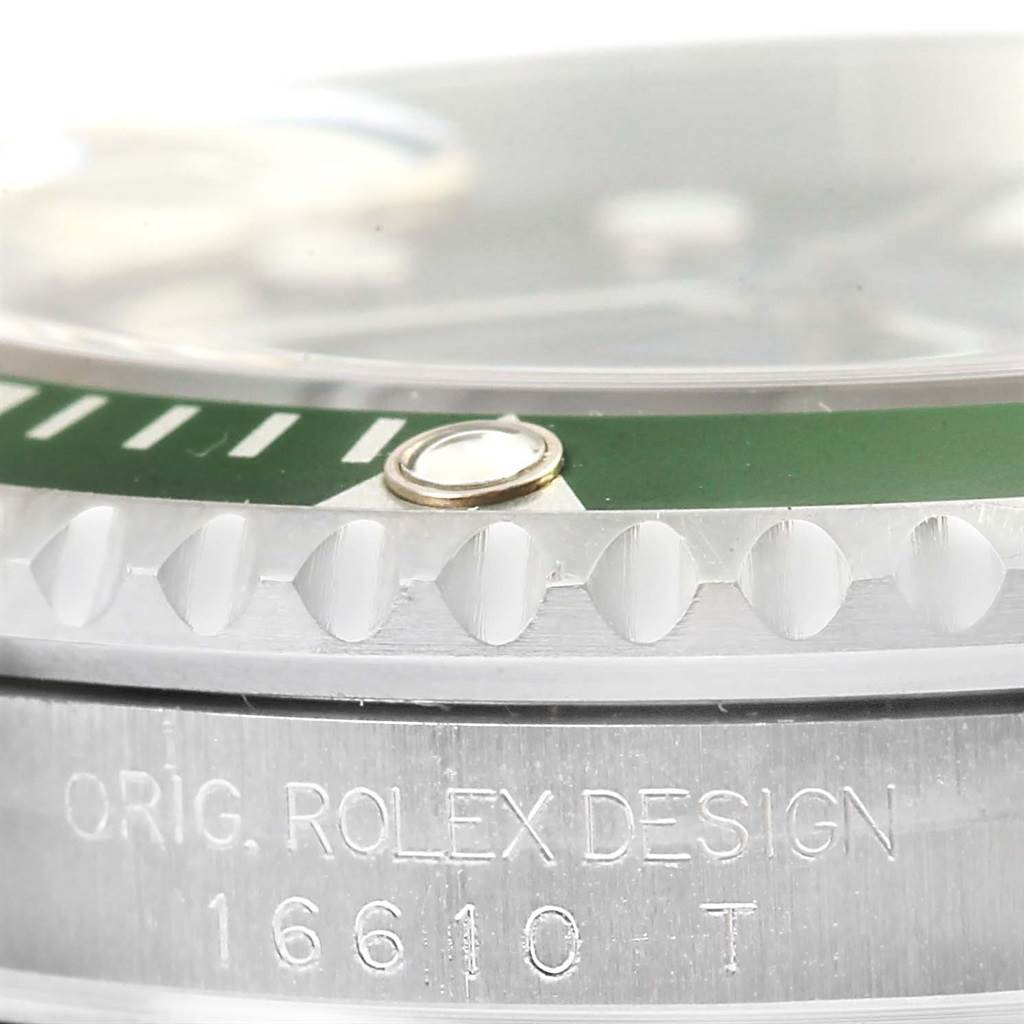 This close-up image shows the side of the bezel and the "ORIG. ROLEX DESIGN" engraving on a Rolex Submariner 16610LV Men
s Stainless Steel Black Dial 16610LV Men
s Stainless Steel Black Dial watch.