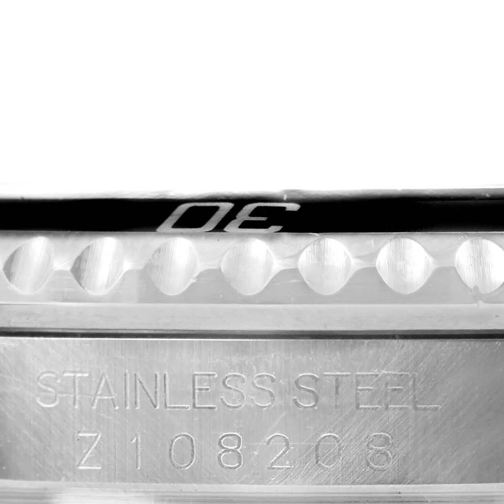 This close-up image of the Rolex Submariner 16610 Men
s Stainless Steel Black Dial 16610 Men
s Stainless Steel Black Dial watch shows the serial number and part of the bezel with the number "30" engraved.