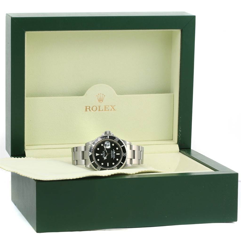 The image shows a Rolex Submariner 16610 Men
s Stainless Steel Black Dial 16610 Men
s Stainless Steel Black Dial watch resting in its open green and cream box, viewed from a front angle.