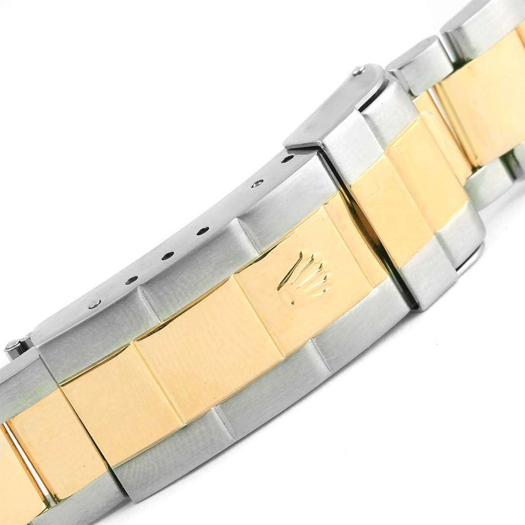 The image shows a close-up of the bracelet and clasp of a Rolex Submariner 16613 Men
s Steel and Gold (two tone) Champagne Dial 16613 Men
s Steel and Gold (two tone) Champagne Dial watch, highlighting the two-tone metal design and Rolex crown logo.