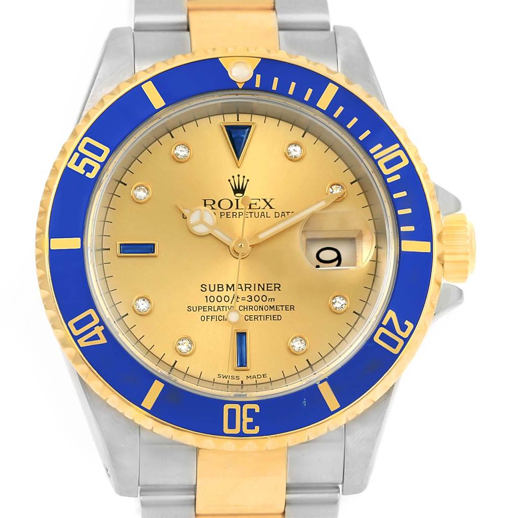 The image shows a front view of a Rolex Submariner 16613 Men
s Steel and Gold (two tone) Champagne Dial 16613 Men
s Steel and Gold (two tone) Champagne Dial watch featuring a gold dial, blue bezel, and two-tone metal bracelet.