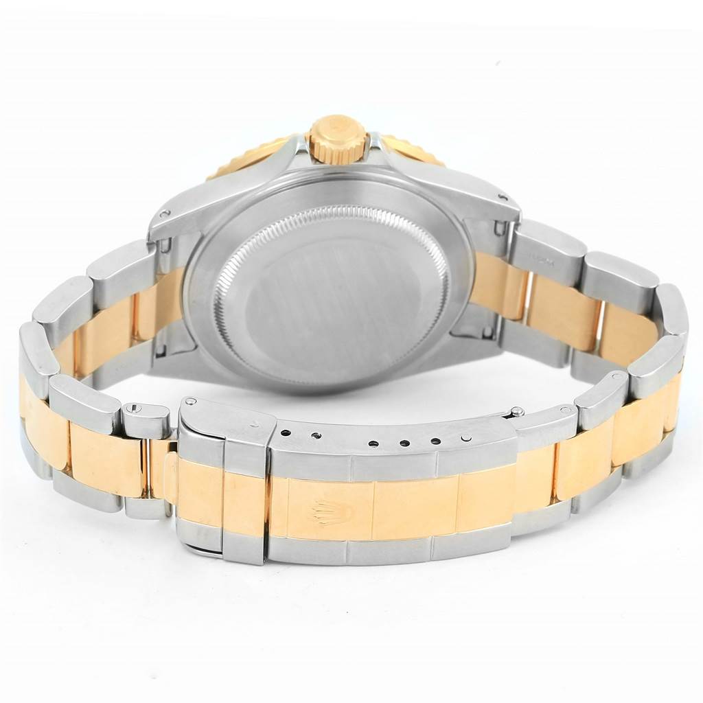 The image shows the back view of a Rolex Submariner 16613 Men
s Steel and Gold (two tone) Champagne Dial 16613 Men
s Steel and Gold (two tone) Champagne Dial watch, highlighting its bracelet, case back, and clasp.
