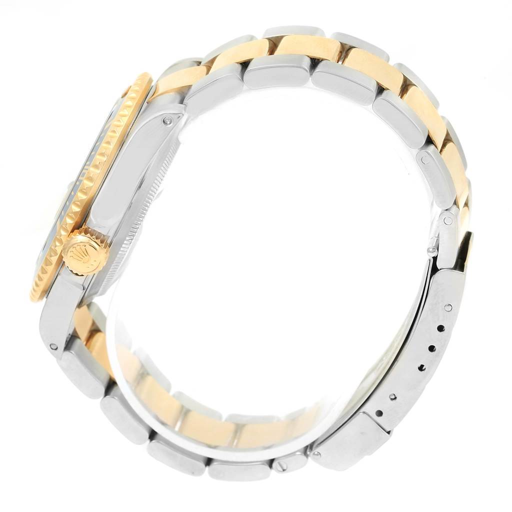 This image shows a side view of a Rolex Submariner 16613 Men
s Steel and Gold (two tone) Champagne Dial 16613 Men
s Steel and Gold (two tone) Champagne Dial watch, highlighting its crown, bezel, and two-tone bracelet.