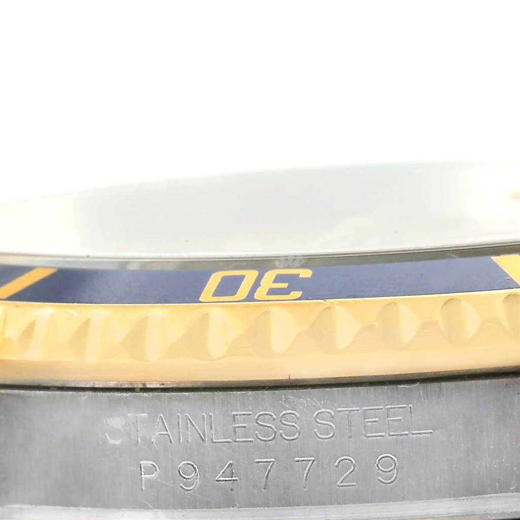 The image shows a close-up of the case side, bezel with the "30" marker, and part of the bracelet of a Rolex Submariner 16613 Men
s Steel and Gold (two tone) Champagne Dial 16613 Men
s Steel and Gold (two tone) Champagne Dial.