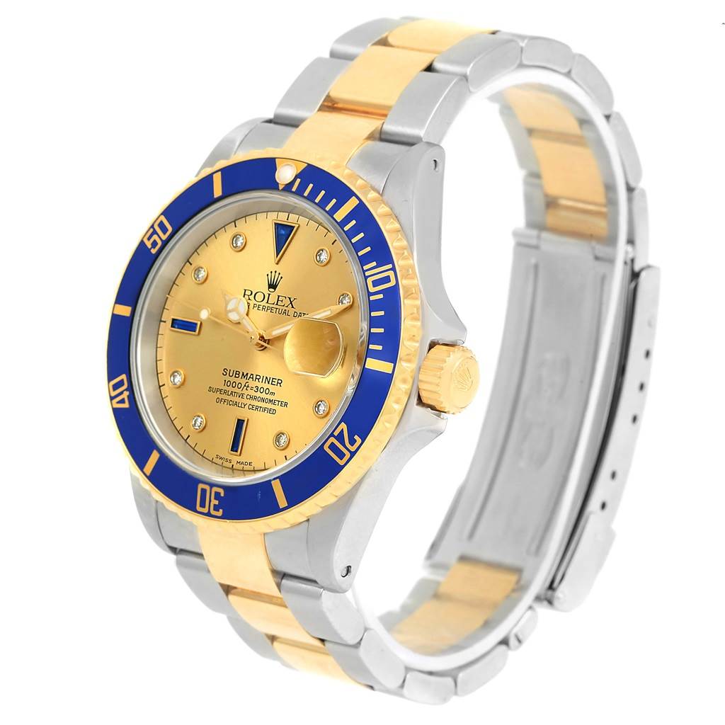 The image shows a Rolex Submariner 16613 Men
s Steel and Gold (two tone) Champagne Dial 16613 Men
s Steel and Gold (two tone) Champagne Dial watch from an angled view, highlighting the gold and blue bezel, dial, and two-tone bracelet.
