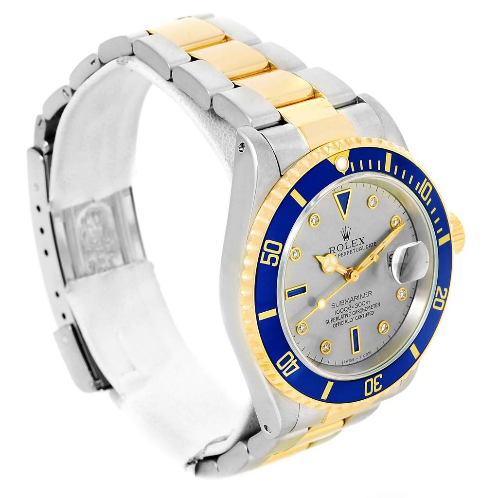 The Rolex Submariner 16613 Men
s Steel and Gold (two tone) Grey Dial 16613 Men
s Steel and Gold (two tone) Grey Dial watch is shown at a slight angle, showcasing the dial, bezel, and part of the two-tone bracelet.